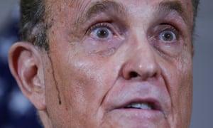 Rudy Giuliani, personal attorney to Donald Trump, speaks as dark-coloured sweat runs down his cheek during a news conference in Washington.